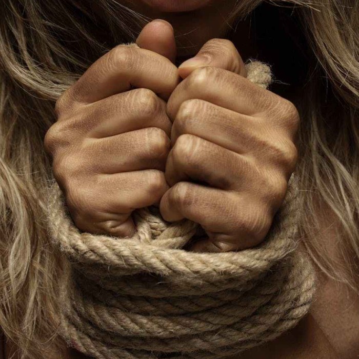 close up photo of woman with her hands tied with rope